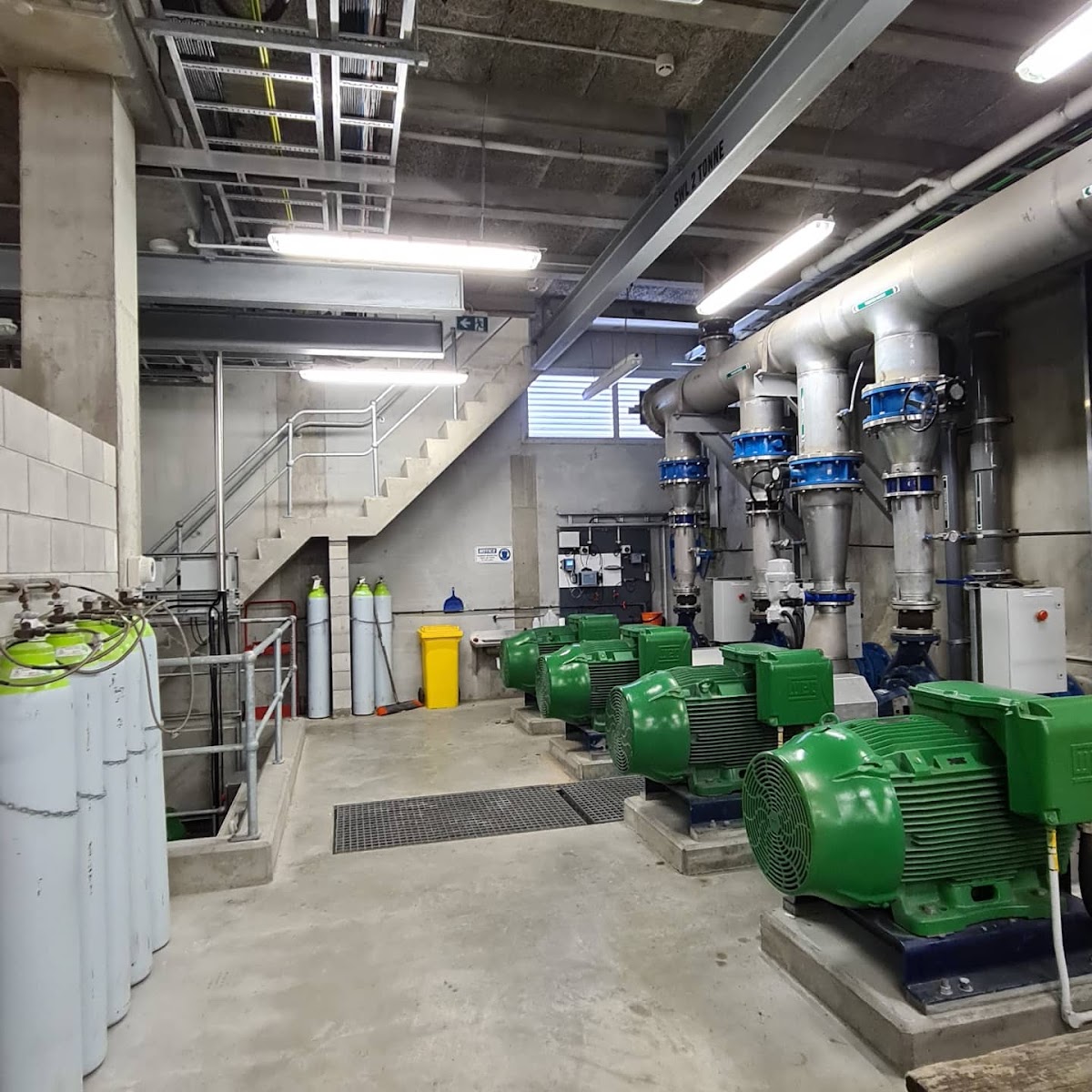 Industrial plant room with electrical control panels and motors