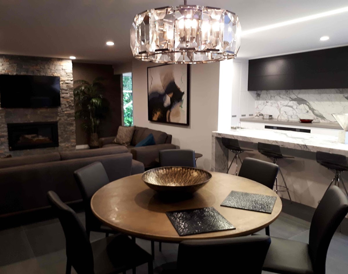 High end lounge with a crystal chandelier and recessed downlights